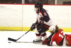 Albert Lea’s Sydney Overgaard gets tripped up by an Austin player Tuesday night at the Albert Lea City Arena. The Tigers beat the Packers 4-1. — Drew Claussen/Albert Lea Tribune