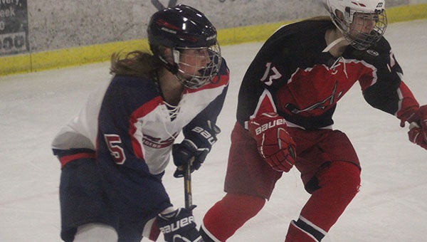 Albert Lea's Hannah Savelkoul attempts to get past an Austin defender. Savelkoul had two goals on Tuesday night. 