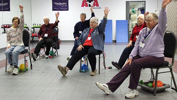Participants in the Monday morning Silver Sneakers class at the Albert Lea Family Y do a stretching exercise at the beginning of their workout. The class is designed to increase muscular strength, range of movement and ease of daily living. --Drew Claussen/Albert Lea Tribune