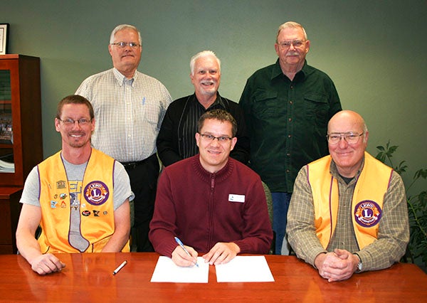 Submitted The Cloverleaf Lions sign an agreement with the city of Albert Lea to restore Edgewater Cottage. In front from left are Cloverleaf Lions President Shay Nelson, City Manager Chad Adams and Lions Secretary Tom Ferleman. In back from left are Bob Goldman, Kim Hanson and Tony Trow. -- Submitted