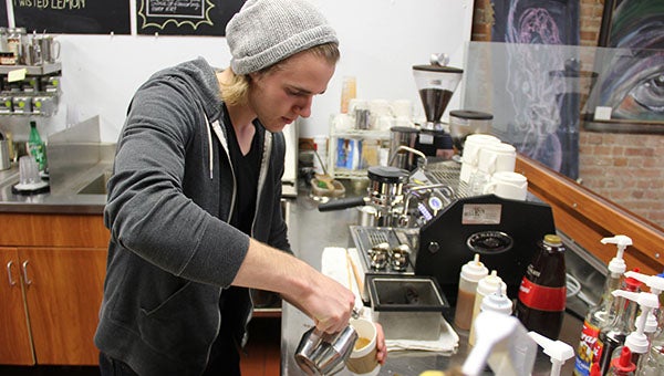 Patrick Hanson makes a latte for a customer Wednesday at Prairie Wind Coffee in downtown Albert Lea. He spent the last six months learning how the place works. --Tim Engstrom/Albert Lea Tribune