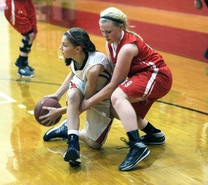 Albert Lea’s Rachel Rehnelt fights for a loose ball with Austin’s Sydney Murphy in the first half of the Tigers’ 63-54 loss to the Packers Tuesday in Over Berven Gym. Albert Lea fell to 1-2 overall. Rehnelt earned one steal and one assist. Albert Lea was led by Megan Kortan who had 24 points and nine rebounds. — Rocky Hulne/Albert Lea Tribune