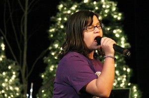 Charley Fleek belts out "Jingle Bell Rock" Tuesday during rehearsal at the Marion Ross Performing Arts Center. "Soft Sounds of Christmas" this year features two children singing.