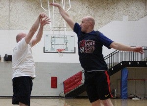 Pat Dahl, right, attempts to block a shot by Troy Doyle during Wednesday night's Community Education open gym at Southwest Middle School.