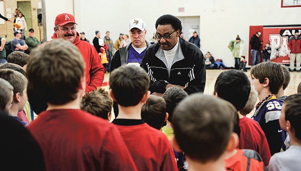 Former Minnesota Viking Chuck Foreman talks to kids before sending them off for drills during a camp by himself and another former Viking, Carl Lee, Saturday morning at Ellis Middle School. --Eric Johnson/Albert Lea Tribune