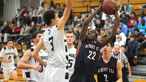 Charlie Morris of Albert Lea shoots over a Faribault defender Tuesday at Albert Lea. Morris had four points, five rebounds, three assists and two steals. — Micah Bader/Albert Lea Tribune