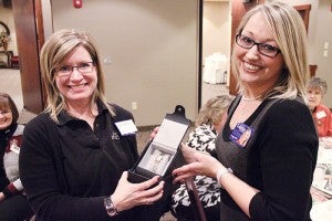 Karla Tukua, left, of Shoe Sensation won a $350 women’s watch from Fisher’s Fine Jewelers Tuesday evening at Business After Hours, hosted by the Albert Lea Tribune at Wedgewood Cove Golf Club. Handing her the watch is Tribune Publisher Crystal Miller. Business After Hours is a monthly gathering of Albert Lea-Freeborn County Chamber of Commerce members. --Tim Engstrom/Albert Lea Tribune