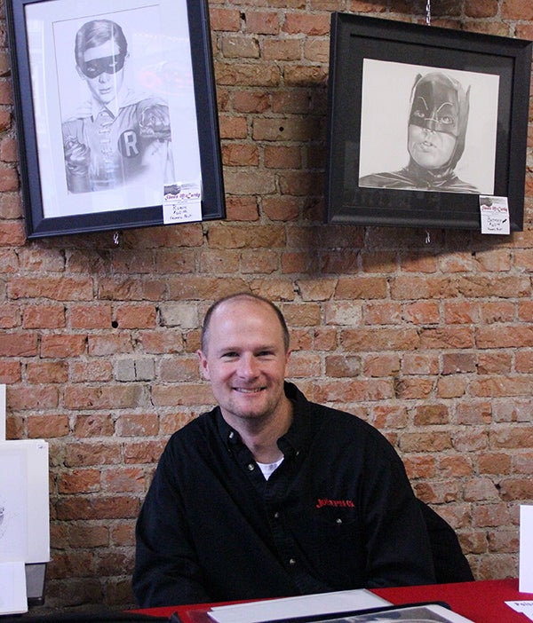Artist Shawn McCarthy sits at his table inside Prairie Wind Coffee Saturday afternoon. McCarthy has been selling his work during the Holiday Bazaar on Broadway the past three weekends. -- Drew Claussen/Albert Lea Tribune 