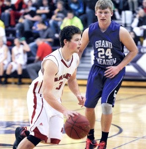 Alden-Conger’s Brady Neel drives past Grand Meadow’s Trenton Bleifus during the first quarter of their game Friday at the Grand Meadow Invitational. — Eric Johnson/Albert Lea Tribune  
