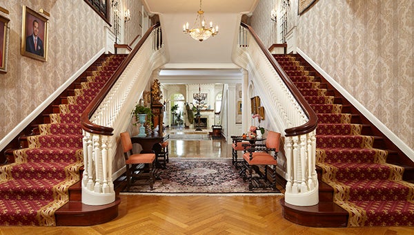 Carpeted twin stairways welcome visitors to the high-ceilinged foyer of the Louis W. Hill House at 260 Summit Avenue. --Karen Melvin Photography
