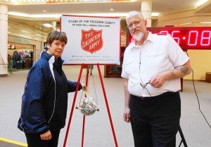 Albert Lea Salvation Army Capt. Jim Brickson, right, accepts a $200 gift from the Sons of Norway social director Bev Wessels on Dec. 4 at the Northbridge Mall.  --Submitted