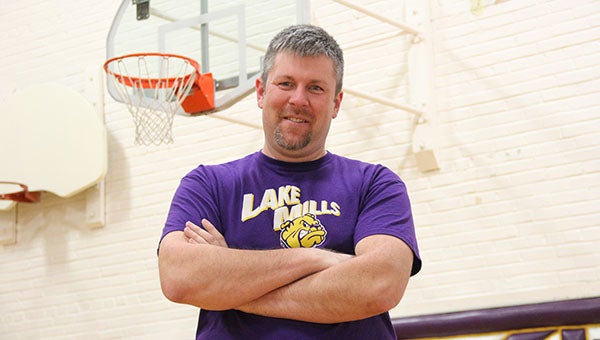 Thad Evans stands on a basketball court at Lake Mills High School. Evans is in his first season coaching the Bulldogs girls’ basketball team. --Micah Bader/Albert Lea Tribune
