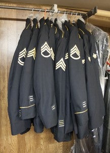 Finished uniforms hang on a rack at Albert Lea Tailors on Tuesday. -- Sarah Stultz/Albert Lea Tribune 