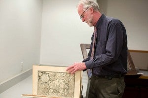 Acquisitions librarian Patrick Coleman pages through maps in a 1595 Ortelius Atlas that is part of a collection of rare items at the Minnesota Historical Society Tuesday in St. Paul.
