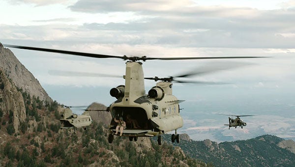 Chinook helicopters in the movie “Lone Survivor” are shown flying over mountains in Afghanistan in this publicity image. Corey Goodnature of Clark Grove was a Chinook pilot. 