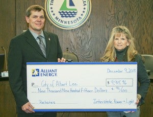 At the Dec. 9 City Council meeting, Alliant Energy presented Mayor Vern Rasmussen with a check for $9,915.96 for rebates relating to energy improvements at City Center. It includes a $5,000 rebate for improvements made to the R-value of the City Hall roof and $4,915.96 from the 2012 lighting upgrades at City Hall which included T-5 fluorescent lighting and occupancy sensors in the building. -- Submitted