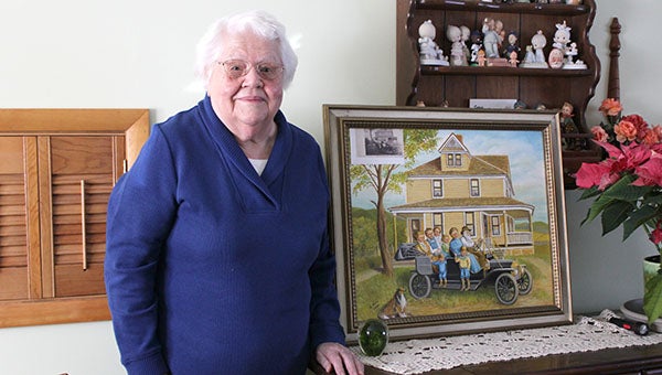 Agnes Boss stands with a picture she painted using an old photo of her ancestors.  --Tiffany Krupke/Albert Lea Tribune