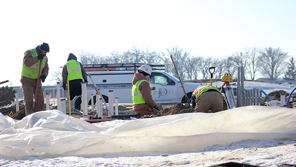 Construction crews work on the foundation of the new Hy-Vee Gas store Thursday afternoon.  --Drew Claussen/Albert Lea Tribune