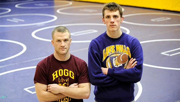 Noah Irons, right, stands in the Lake Mills wrestling room Friday after practice next to his coach Alex Brandenburg. — Micah Bader/Albert Lea Tribune