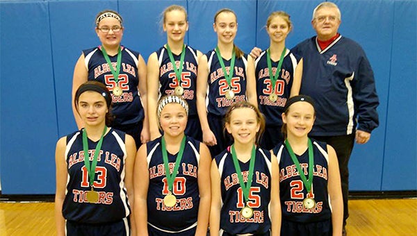 The Albert Lea seventh-grade traveling girls’ basketball team took second place at a tournament Jan. 5 in Lyle. Front row from left are Megan Johnson, Lexus Saltou, Emma Loch and Taysha Sternhagen. Back from left are Khira Hacker, Gigi Otten, Jayna Finseth, Julissa Gilbertson and coach Lowell Wulff. Anna Grossman and Rylie Tollefson are not pictured. — Submitted