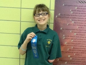 Fourth-grader Allie Bassett won the spelling bee at St. Theodore Catholic School and will advance to the regional spelling bee on Feb. 11. -- Submitted 