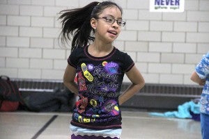 A student jumps in time to the music during dane club. The class learns a new dance each practice.