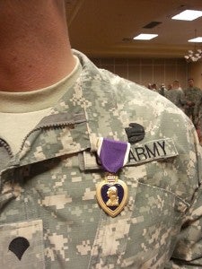 Gillespie displays his Purple Heart during the ceremony in Independence, Mo. Gillespie served for 14 years.