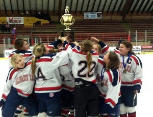 The Albert Lea U12 girls’ hockey team hoists the trophy for first place at the Packer Classic on Jan. 12 after beating Le Sueur 4-0 in the championship game. — Submitted  