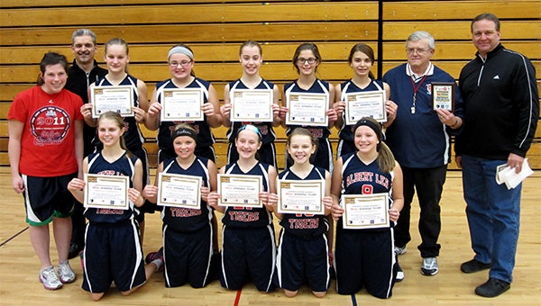 The Albert Lea seventh-grade girls’ basketball team holds certificates Tuesday as the recipients of the Real Winning Team Award. Front row from left are Julissa Gilbertson, Lexus Saltou, Taysha Sternhagen, Emma Loch and Rylie Tollefson. Back row from left are coach Chelsea White, Mark Arjes of Youth 1st, Gigi Otten, Khira Hacker, Jayna Finseth, Anna Grossman, Megan Johnson, coach Lowell Wulff and Mark Hendricks. — Submitted