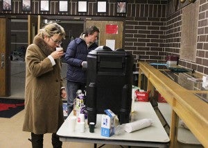Natalya and Wilhelm Dick get some coffee at the emergency shelter set up at the National Guard Armory in Albert Lea this morning. -- Sarah Stultz/Albert Lea Tribune