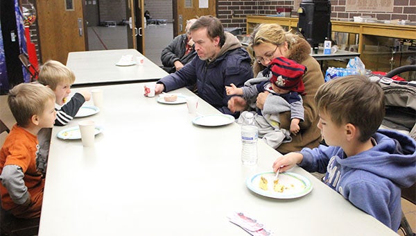 Wilhelm Dick and his wife, Natalya, eat breakfast at the National Guard Armory in Albert Lea Monday morning with their four children, Samuel, Michael, Gabriel and Daniel. The family was headed home to Kansas City, Mo., from Minneapolis. -- Sarah Stultz/Albert Lea Tribune 