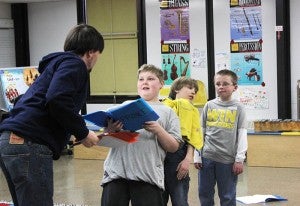 Chance Wall, professional actor with Prairie Fire Children’s Theatre, practices a scene of “Beauty and the Beast” with Colin Farr, playing the Prince, and two other students Wednesday afternoon at the school. 
