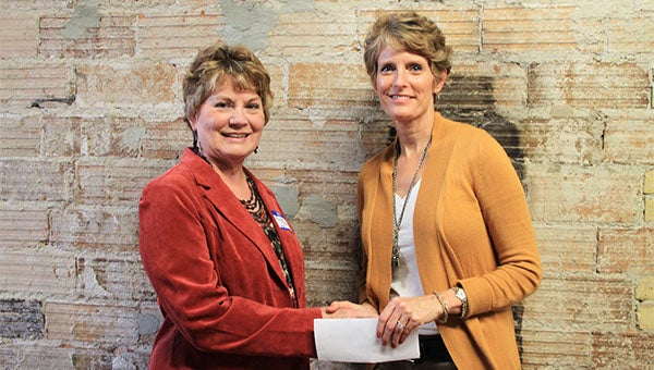 Freeborn County Communities Foundation chairwoman Jill Peterson, right, shakes hands with Albert Lea Community Theatre President Rosalyn Truax. -- Submitted 