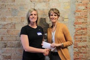 Freeborn County Communities Foundation chairwoman Jill Peterson, right, shakes hands with Albert Lea Family Y Fitness Director Susie Hulst. --Submitted
