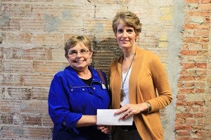 Freeborn County Communities Foundation chairwoman Jill Peterson, right, shakes hands with former STARS/Community Mentor Connection coordinator Carolyn Smith.