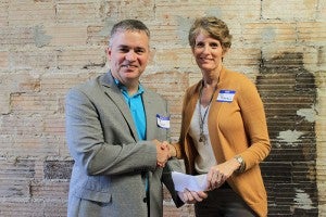 Freeborn County Communities Foundation chairwoman Jill Peterson, right, shakes hands with Albert Lea Area Schools Superintendent Mike Funk. --Submitted