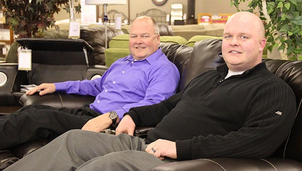 David Janisch, left, and his son, Adam Janisch, sit on chairs at their Slumberland store in Albert Lea. They purchased the business and its building in December. --Tim Engstrom/Albert Lea Tribune