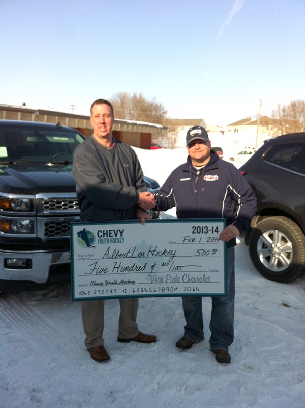 Paul Schuster, left, general manager of Vern Eide Cherolet, presents a check to Jason Fornwald, president of the Albert Lea Hockey Association, on Albert Lea Hockey Day on Saturday at the City Arena. Part of the day's activities was Chevy's chance to win the ultimate hockey experience. -- Submitted 