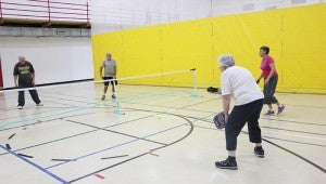 Clockwise from back left, Ron Hansen, John Domes, Joleen Domes and Wendy Hagen play pickleball on a portion of the gym at the Albert Lea Family Y. -- Sarah Stultz/Albert Lea Tribune 