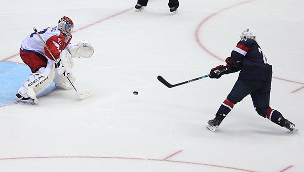 USA forward T.J. Oshie, right, scores a goal against Russian goalie Sergei Bobrovsky in a shootout of a men’s hockey game at Bolshoy Ice Dome during the Winter Olympics in Sochi, Russia on Saturday. USA defeated Russia, 3-2. -- MCT
