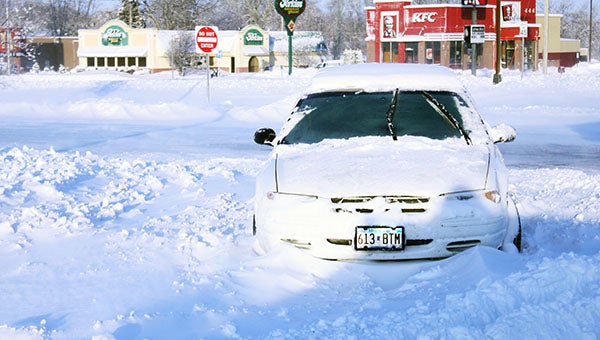 A white car sits stuck at the intersection of East Main Street and Prospect Avenue in Albert Lea Friday morning. -- Sarah Stultz/Albert Lea Tribune    