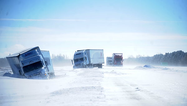Two semis sit stranded in the ditch of northbound Interstate 35 Friday a mile south of the Blooming Prairie and New Richland exit. -- Micah Bader/Albert Lea Tribune