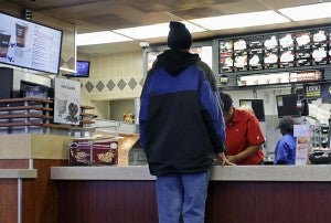 A customer places an order Thursday at a McDonald’s restaurant in St. Paul. The 2014 Legislature will convene Tuesday in St. Paul where Democrats have pledged to raise Minnesota’s minimum wage above its current $6.15 per hour level. — AP