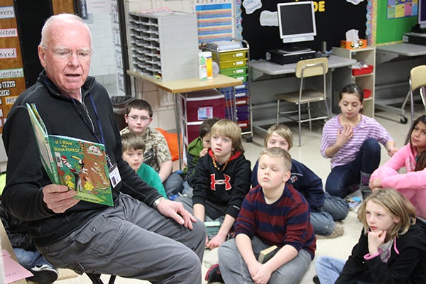 Sibley Elementary School volunteer Steve Lund explains different types of rain forests to students in Allison Miller's fourth-grade class Monday. He was among several community members to read books to students. -- Tim Engstrom/Albert Lea Tribune