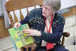 Sibley Elementary School volunteer Beth Spande reads the Dr. Seuss book "If I Ran the Rain Forest" to fourth-graders in Erika Youlden's class Monday. -- Tim Engstrom/Albert Lea Tribune 