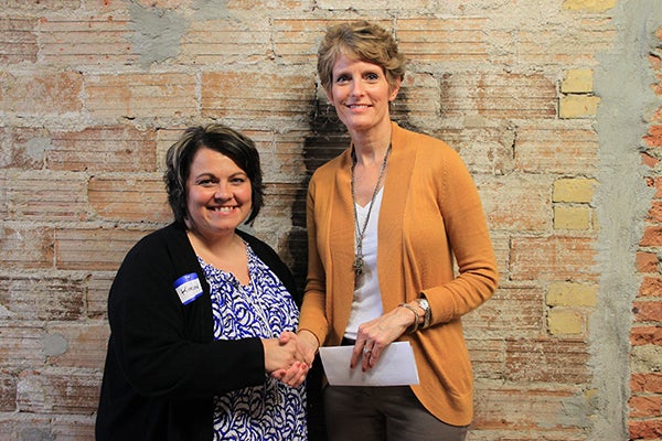 Freeborn County Communities Foundation chairwoman Jill Peterson, right, shakes hands with Kim Nelson, director of The Children’s Center. -- Submitted 