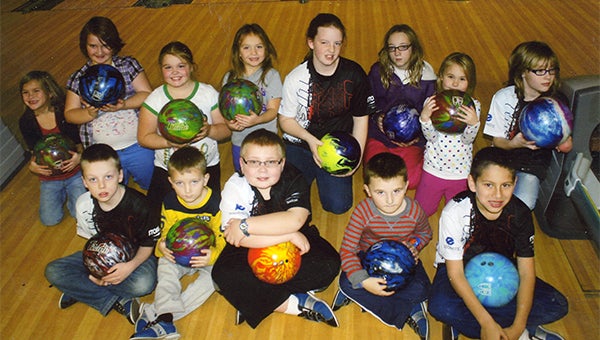 Members of the Wednesday After-School Bumper League hold bowling balls at Holiday Lanes. — Submitted
