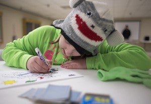 Nine-year-old Marissa Leeman colors during the Terrific Tuesday day camp put on by Albert Lea Parks and Recreation on Tuesday at City Arena. – Colleen Harrison/Albert Lea Tribune