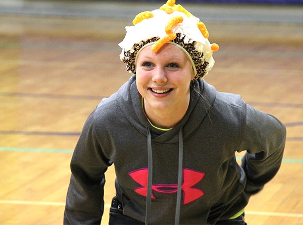 Glenville-Emmons students paired up for the cheese puff throwing game at the Ag Olympics. One participant put on a shower cap and covered it with shaving cream while their partner threw cheese puffs at their head. – Tiffany Krupke/Albert Lea Tribune
