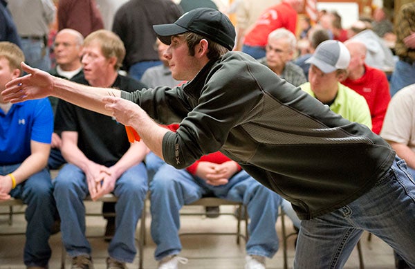 John Hubly Jr. looks to the board after throwing a dart during the Brotherhood Dartball League final tournament Monday at Emmons Lutheran Church. – Colleen Harrison/Albert Lea Tribune
